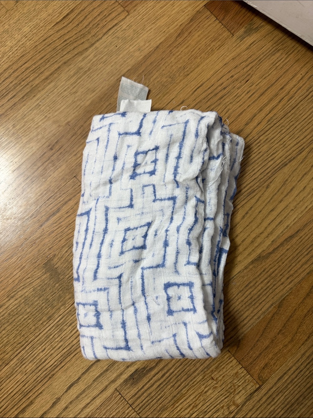 aden + anais White Swaddle Blanket with Blue Geometric Shapes.